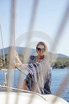 Young woman relaxing on the yacht on sea at sunny day