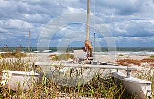 Young Woman Remote Working On Line Using Laptop On Boat At Beach