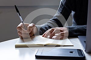 Young woman remotely working on the computer in his home office