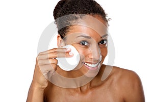 Young woman removing make up with pad