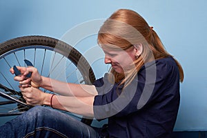 Young woman repairing a bike. pretty young girl repairing bicycle in bike shop