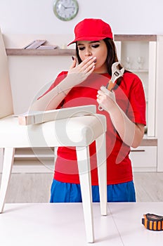Young woman repairing chair at home