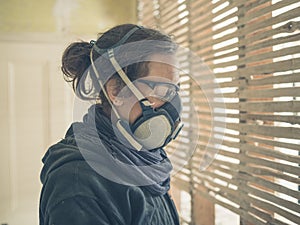 Young woman repairing wattle and daub wall