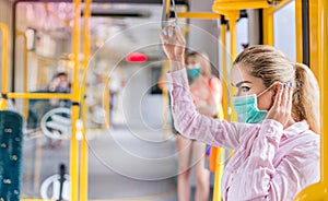 Young woman with respiratory mask traveling in the public transport. Public transport during the coronavirus - concept.