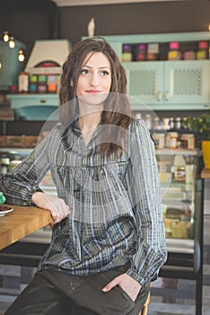 Young woman in restaurant drinking coffee