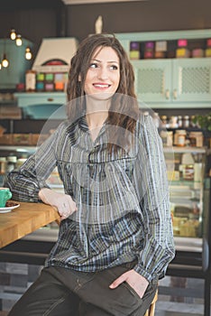 Young woman in restaurant drinking coffee