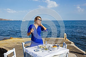 Young woman in a restaurant by the sea