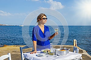 Young woman in a restaurant by the sea