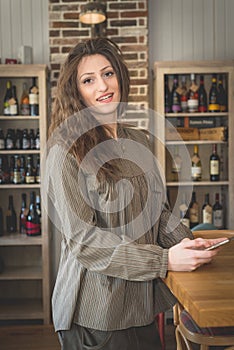 Young woman in restaurant talkin on the phone