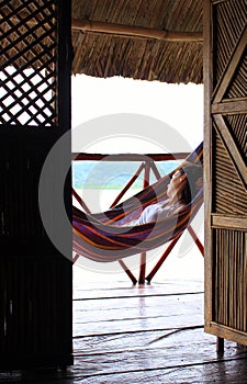 Young woman resting on a hammock in Yandup Island lodge, Panama