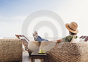 Young woman resting on hotel terrace. Vacations and summer fun concept. Beautiful girl enjoying life