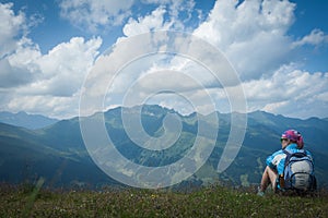 Young woman resting on a mountain hike