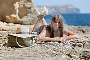 Young woman resting on rock