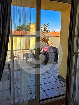 Young woman resting on terrace at home. Beautiful girl enjoying life.