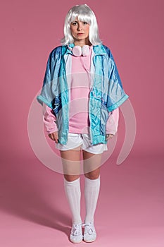 Young woman with retro clothes listening to music and dancing