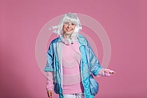 Young woman with retro clothes listening to music and dancing