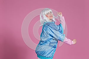 Young woman with retro clothes listening to music and dancing