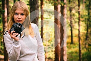 Young Woman with retro photo camera outdoor