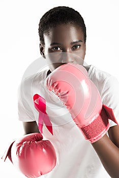 young woman with ribbon on t-shirt boxing and looking at camera