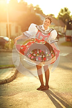 young woman in a richly decorated ceremonial folk dress/