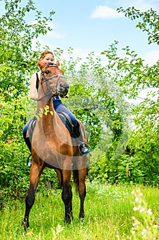 Young woman ridding on a horse