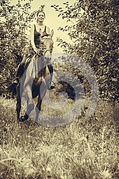 Young woman ridding on a horse