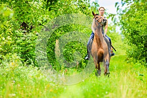 Young woman ridding on a horse