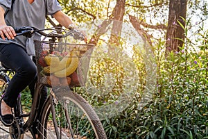 Young woman ride with bicycle to home from shopping