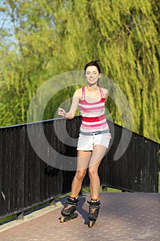 Young woman ride rollerblades