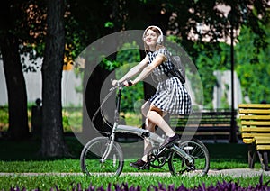 Young woman rides bicycle in the park