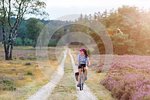 Young woman riding bicycle in the countryside