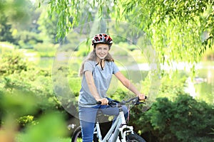 Young woman riding bicycle in park