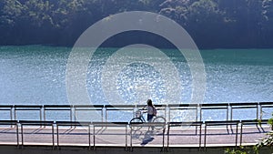 Young woman riding bicycle on Sun Moon lake bike trail