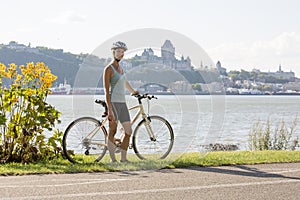 Young Woman Riding Bike outside with quebec view