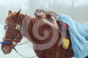 Young woman riding a horse