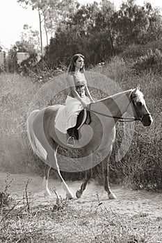 Young woman riding on horse (motion blur)