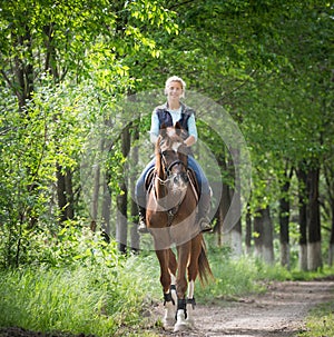 Young woman riding a horse