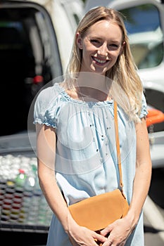 young woman riding shopping cart full food