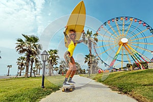 Young woman riding on skate with surf in amusement park to the beach.