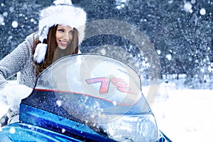 young woman riding a snowmobile