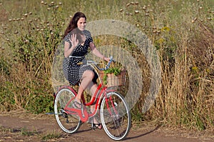 Young woman riding vintage bicycle