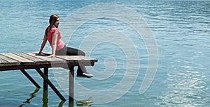 Young woman on river shore