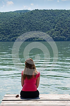 Young woman on river shore