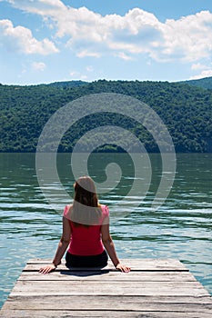 Young woman on river shore