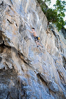 Young woman rock climbing on white mountain