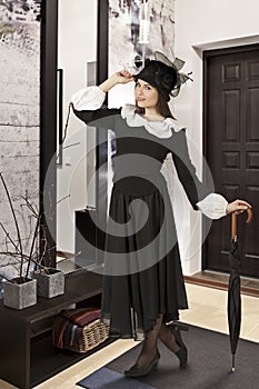 Young woman in the role of Mary Poppins indoors