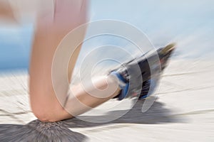 Young woman on roller skates falling down on ground, asphalt