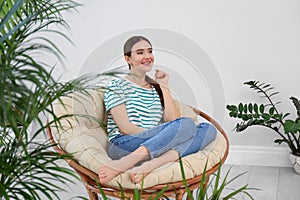 Young woman in room decorated with plants