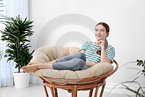 Young woman in room decorated with plants