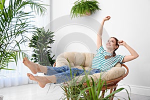 Young woman in room decorated with plants photo